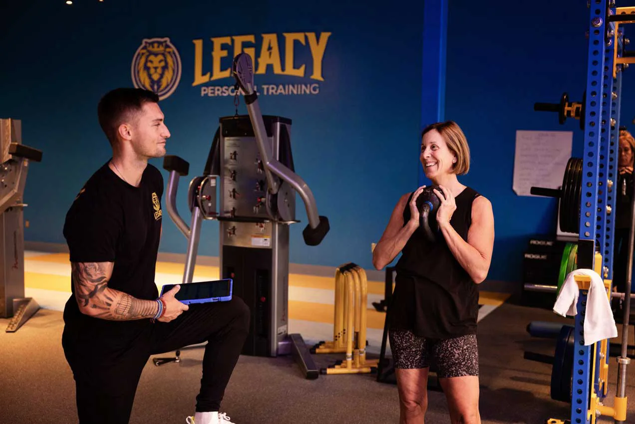 Personal trainer coaching a client during a strength training session at Legacy Personal Training gym in Scottsdale, AZ